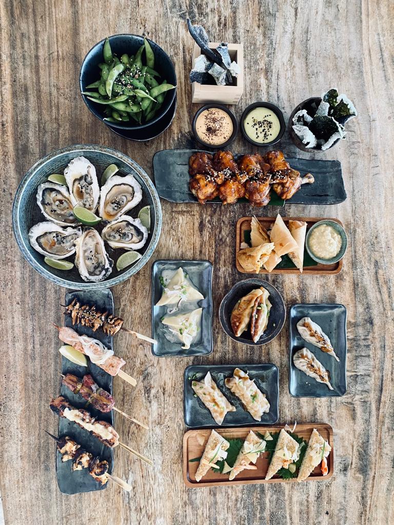 Assorted-Japanese-Appetizers-Platter-with-Sushi-Skewers-Dumplings-and-Oysters